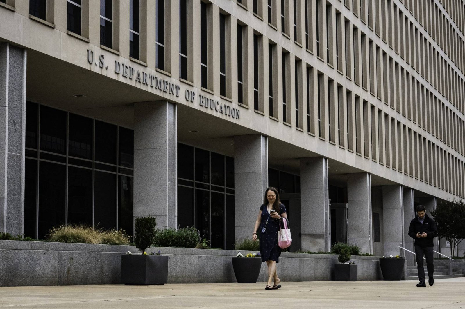 Woman walking past federal building